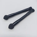 Double-headed makeup brush with black sponge end and pointed brush end on wooden handle