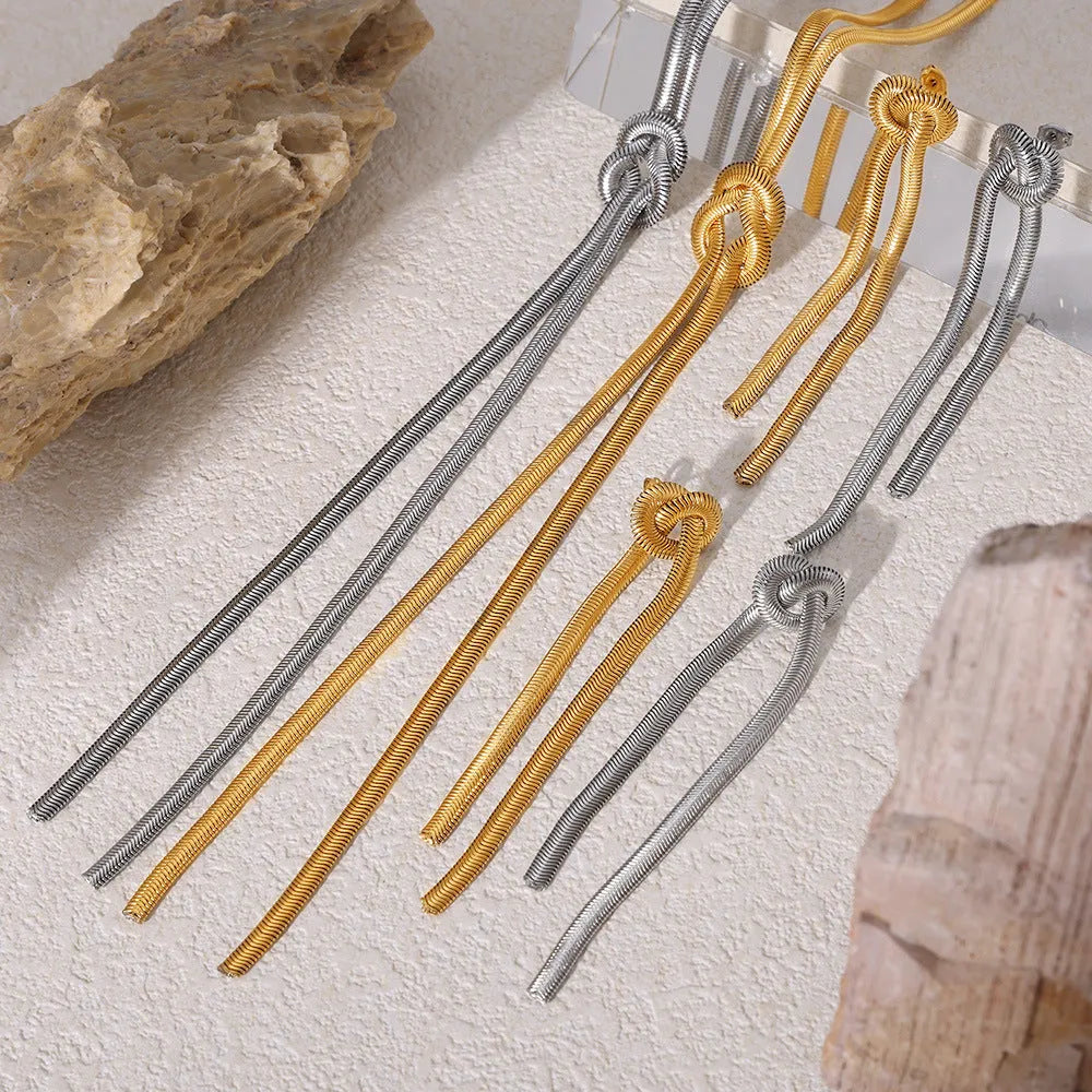 Gold electroplated titanium steel necklace with knotted tassel pendant and matching earrings