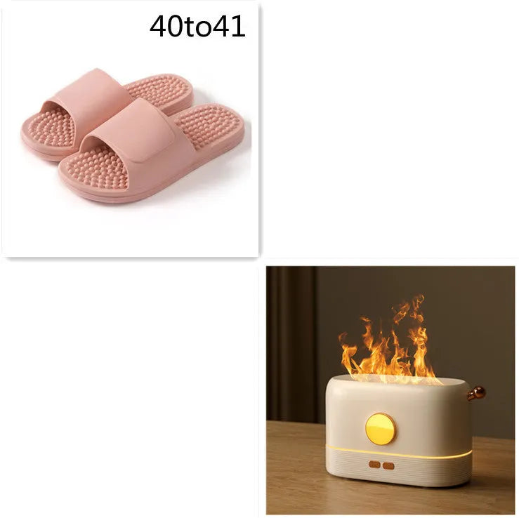 Black USB desktop humidifier diffuser with glowing simulated flame effect on a wooden table.