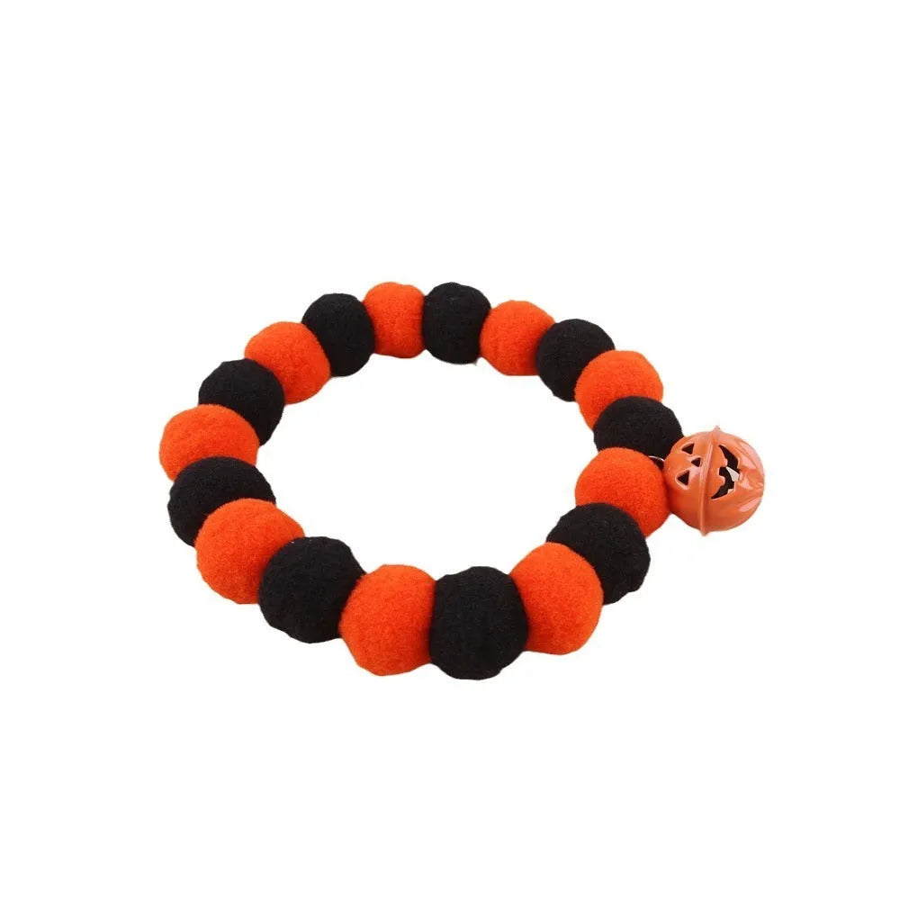 Halloween cat collar with orange pumpkin design showing trick or treat text and ghost bat decorations