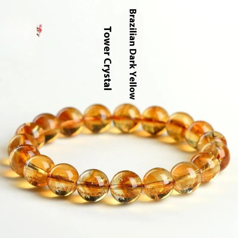 Natural yellow citrine gemstone bracelet showing geometric cut beads on a string.