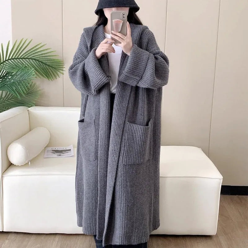 Loose hooded cardigan coat with raglan sleeves in acrylic fabric showing extended length