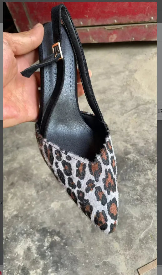 Leopard print suede women's sandals with a pointed toe and a heel.