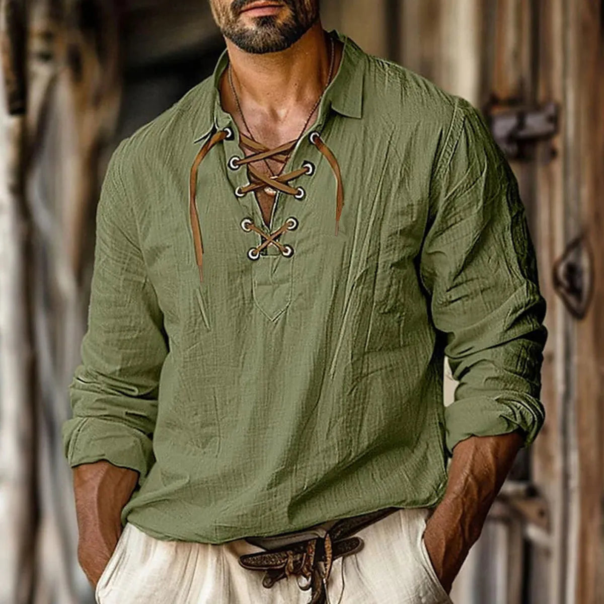 Men's loose fit long sleeve linen blend shirt in blue with a lapel collar, laid flat.