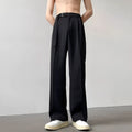 Women's black wide leg straight cut trousers with a non-iron finish on a neutral background