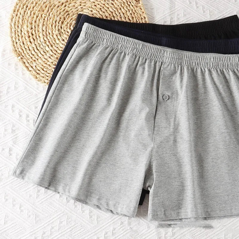 Men's solid colour cotton boxer shorts with a high waist and loose fit on a neutral background.
