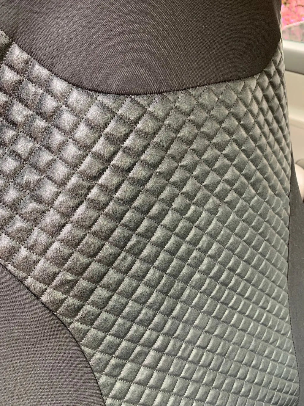 Black quilted automotive seat cover set made from PU and polyester fabric with plastic hooks.