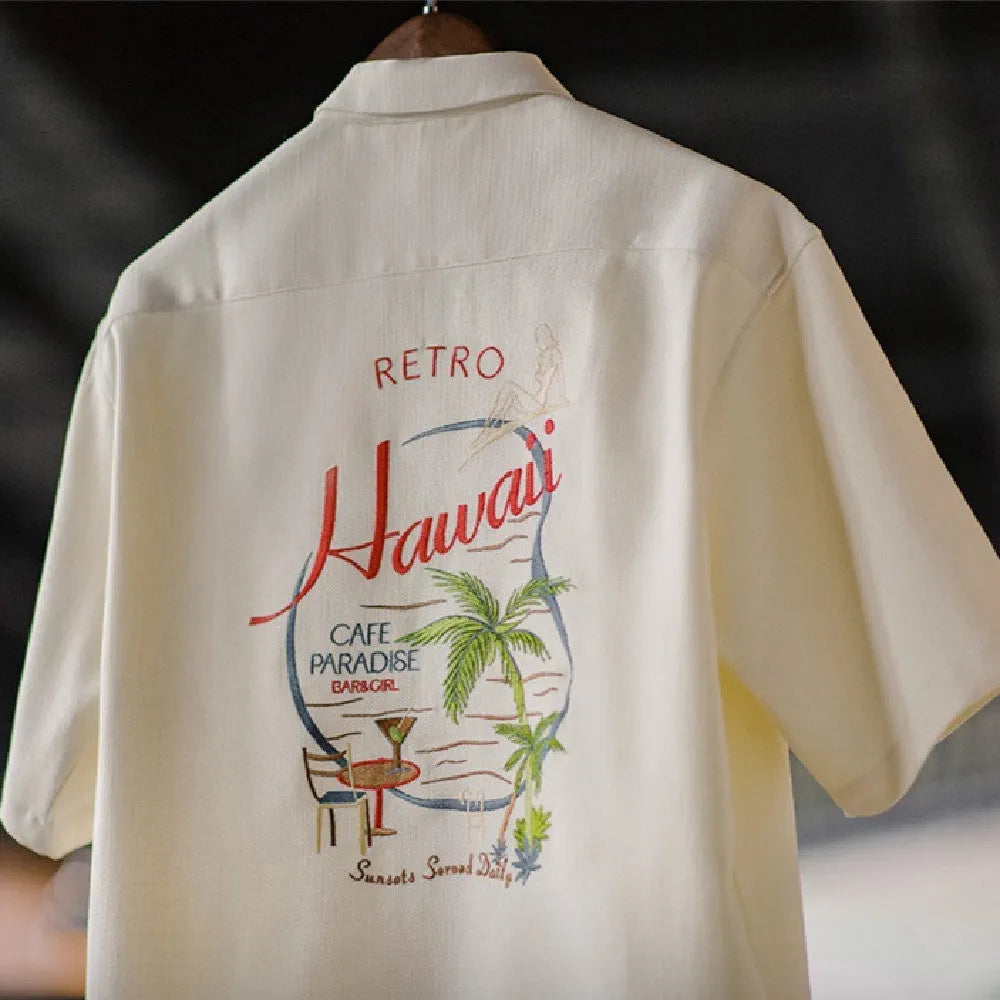 A light apricot men's shirt with a bamboo plant pattern and a relaxed Cuban collar.