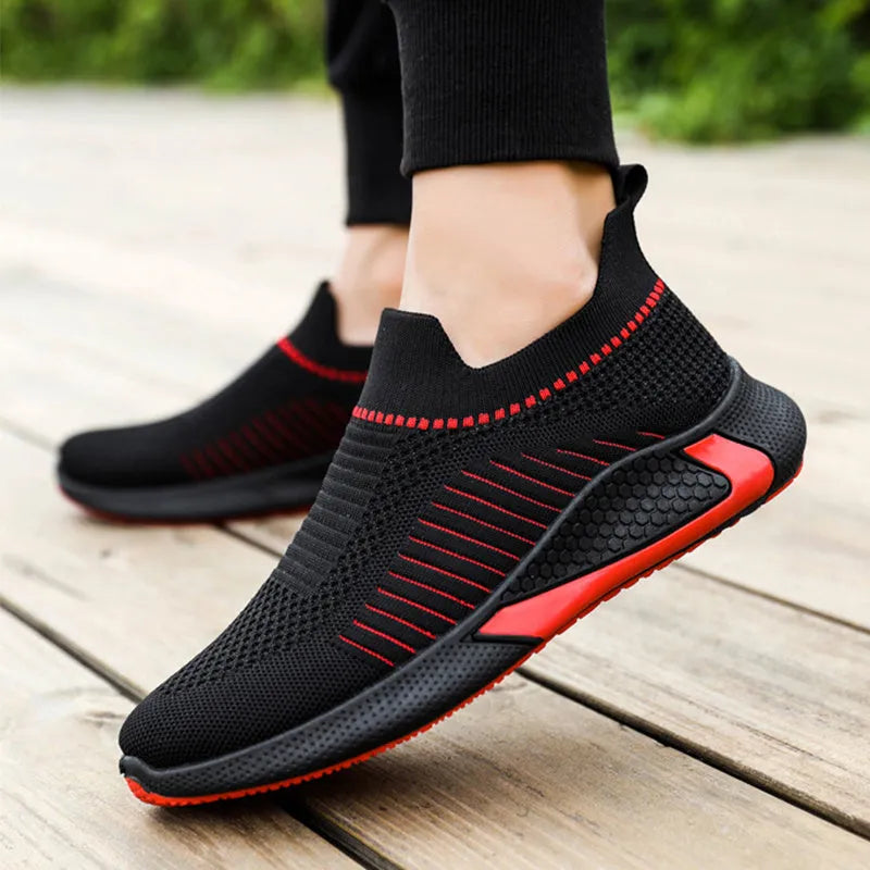 Men's black and white striped mesh slip-on sneakers with lace-up front on a white background