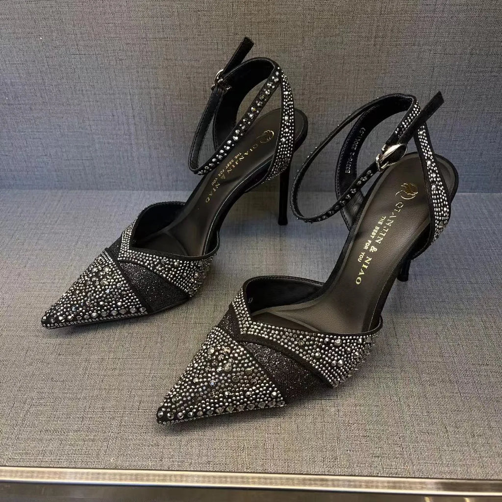 Women's black stiletto heels with pointed toe, hollowed design and red sole