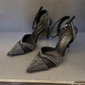 Women's black stiletto heels with pointed toe, hollowed design and red sole