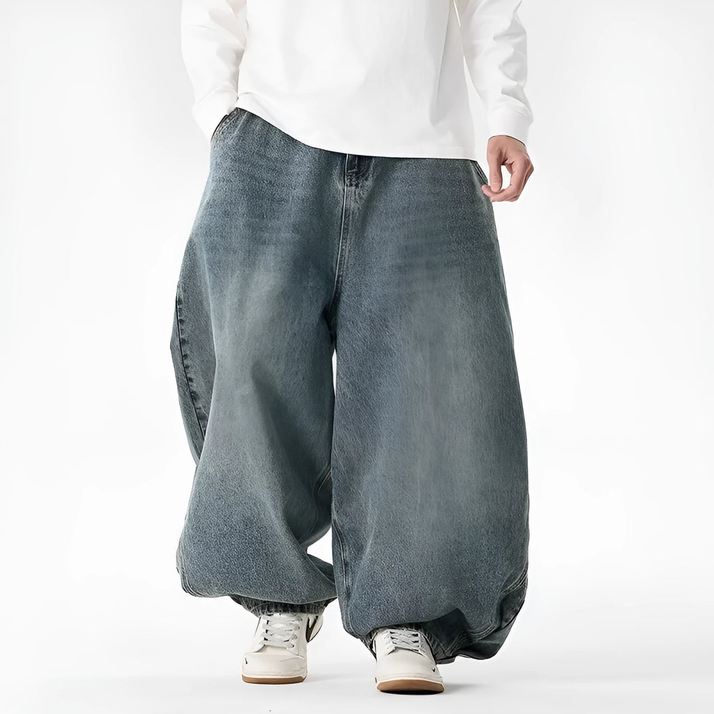 Man wearing black plus-size baggy denim jeans with a straight leg and low waist.