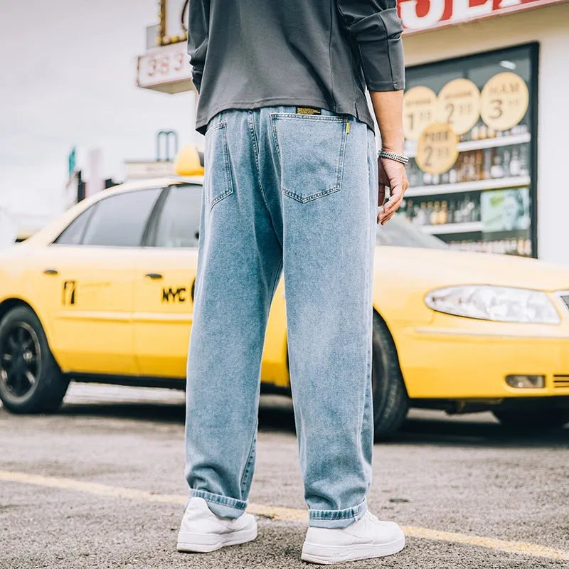 Men's loose straight-leg casual jeans in dark blue cotton fabric with a zip fly.