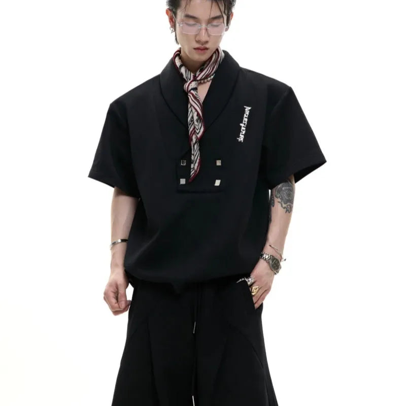 Men's dark grey cotton sports suit with V-neck short sleeve jacket and matching bottoms showing padded shoulder detail