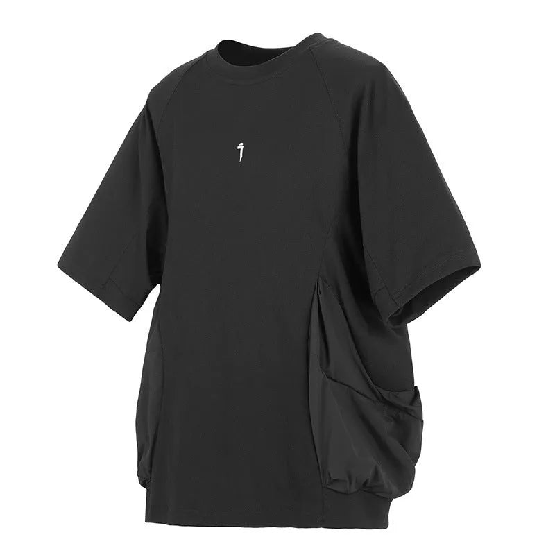 Man wearing a loose grey cotton T-shirt with large side pockets, round neck, and short sleeves.