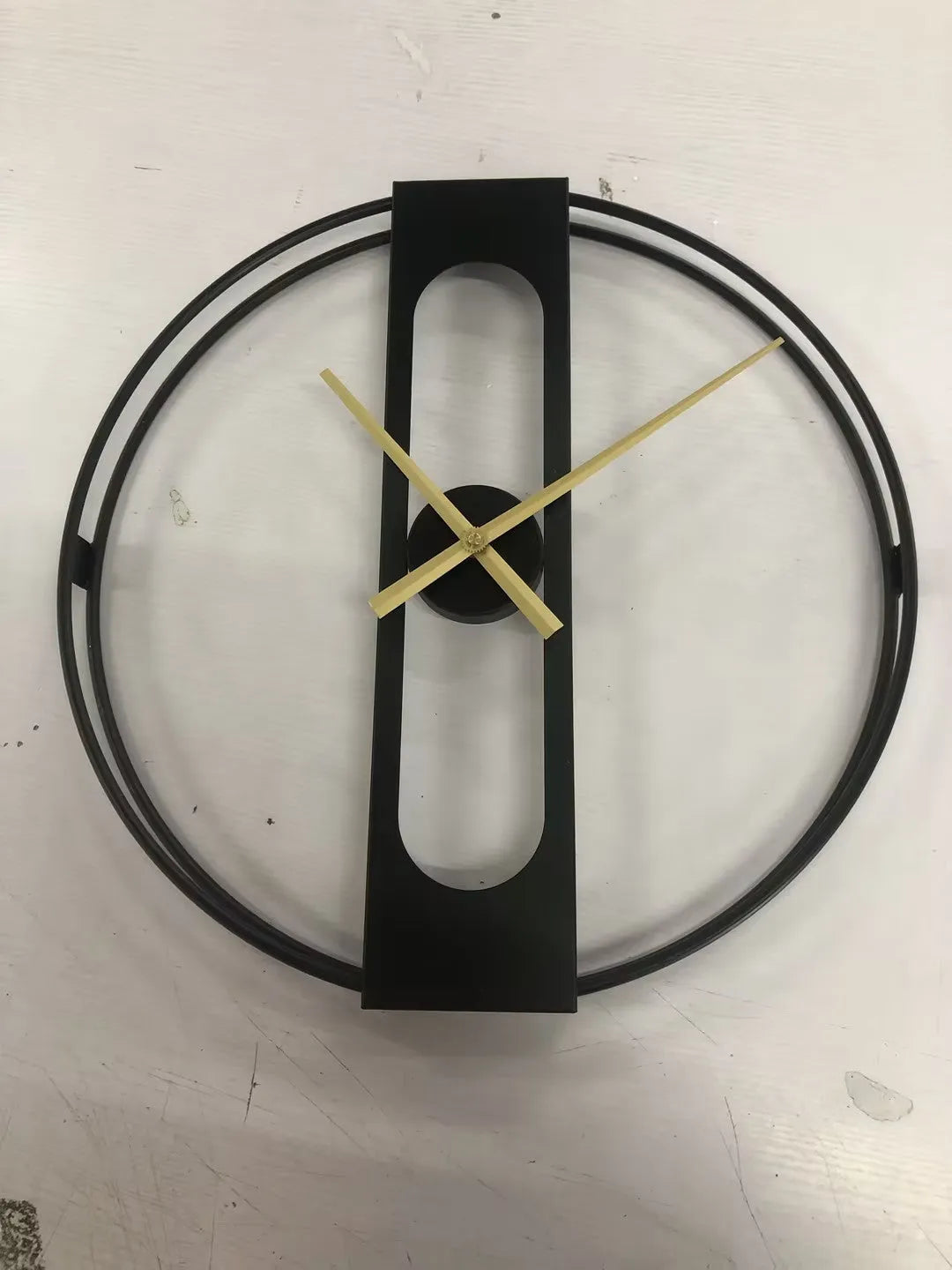 Round metal wall clock with 50cm diameter face in black or gold finish.