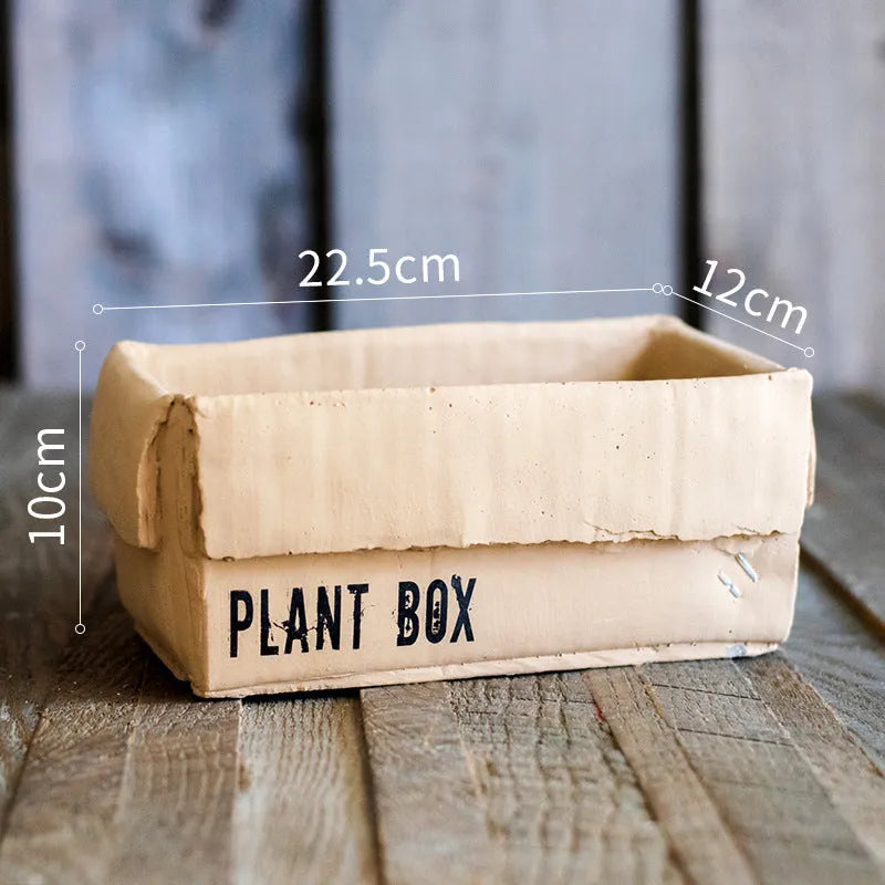 Nordic-style cement brown paper box flowerpot for indoor planting on a floor.