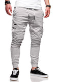Man wearing light blue loose-fit casual polyester trousers with patch pockets and an elasticated waist.