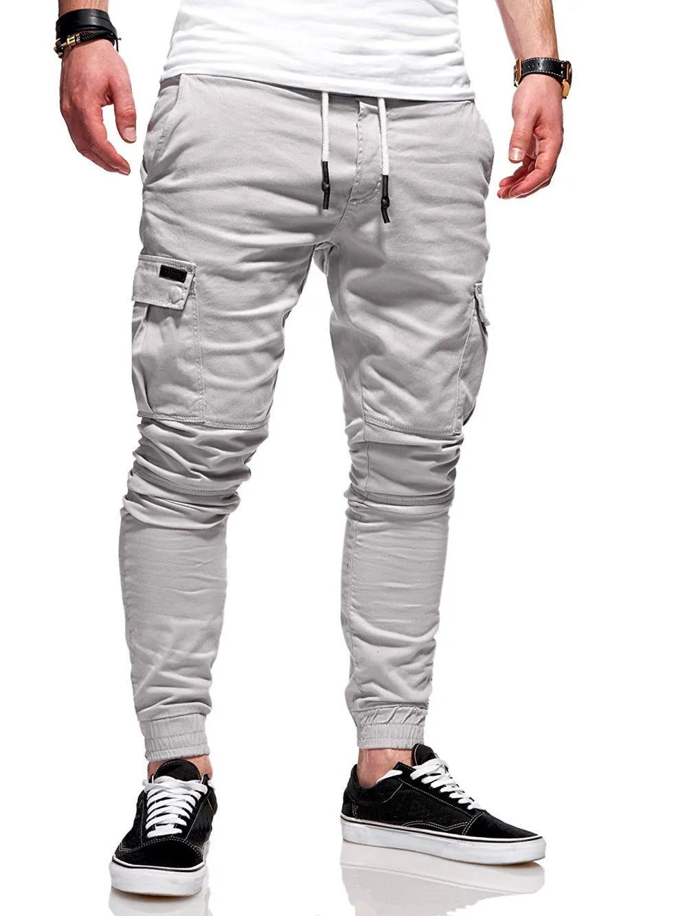 Man wearing light blue loose-fit casual polyester trousers with patch pockets and an elasticated waist.