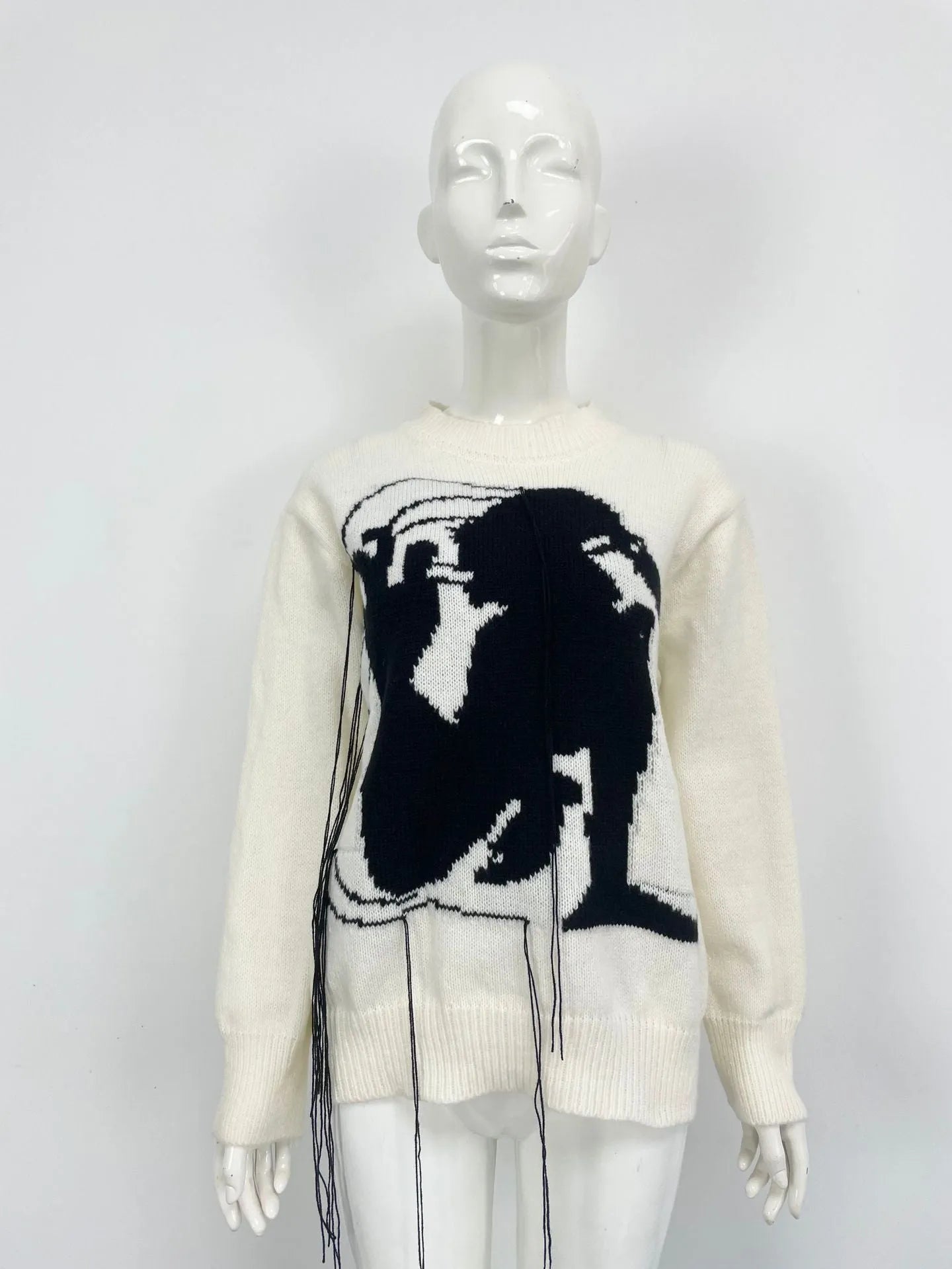 Women's loose alpaca wool sweater with abstract pattern and tassel detailing in street fashion style