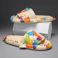 Pair of grey shark design open toe EVA home slippers on a white background.