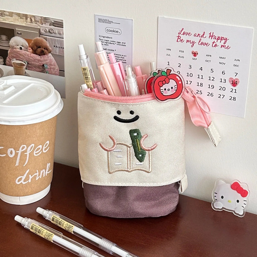 Cartoon design collapsible pencil case in brown or green Oxford fabric, shown open to display large 17cm x 14cm storage capacity.
