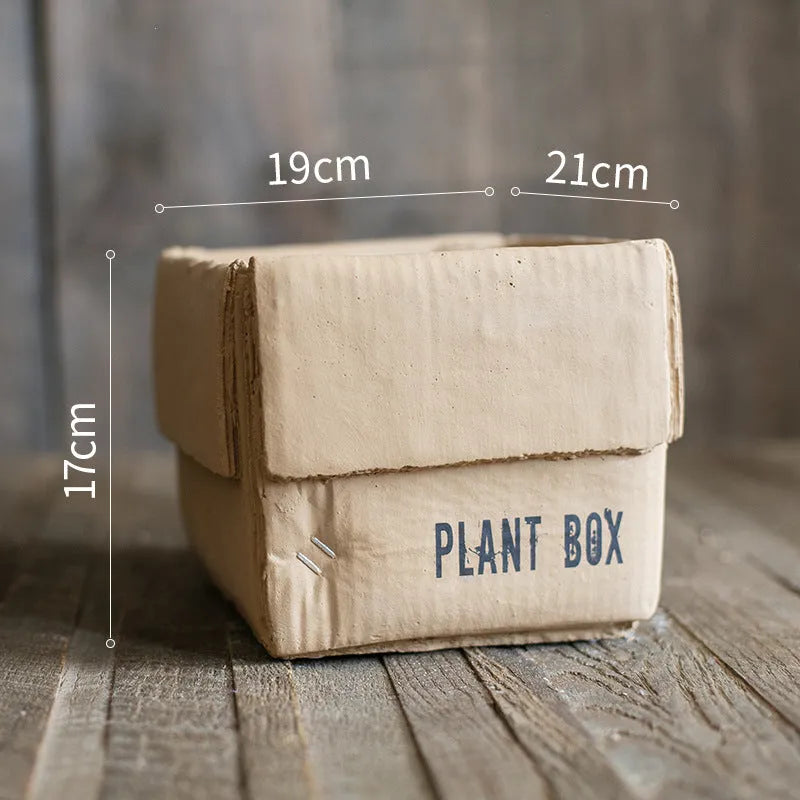 Nordic-style cement brown paper box flowerpot for indoor planting on a floor.