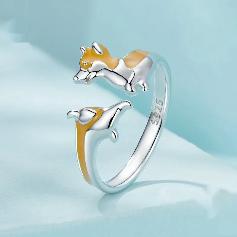 Adjustable silver ring with a raised cartoon corgi dog design on the band.