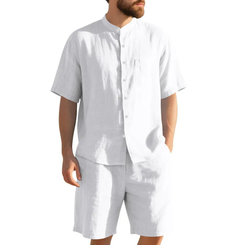 Men's light blue linen two-piece suit with short-sleeved henry collar shirt jacket and shorts on a hanger.