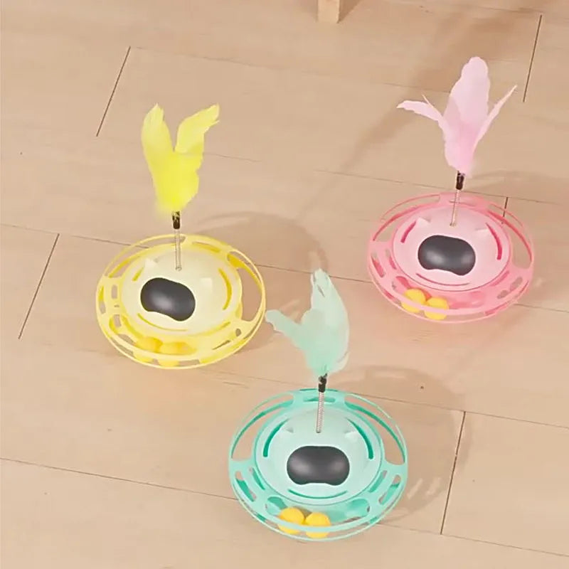 Pink cat stick toy with a tumbler turntable design on a white surface.