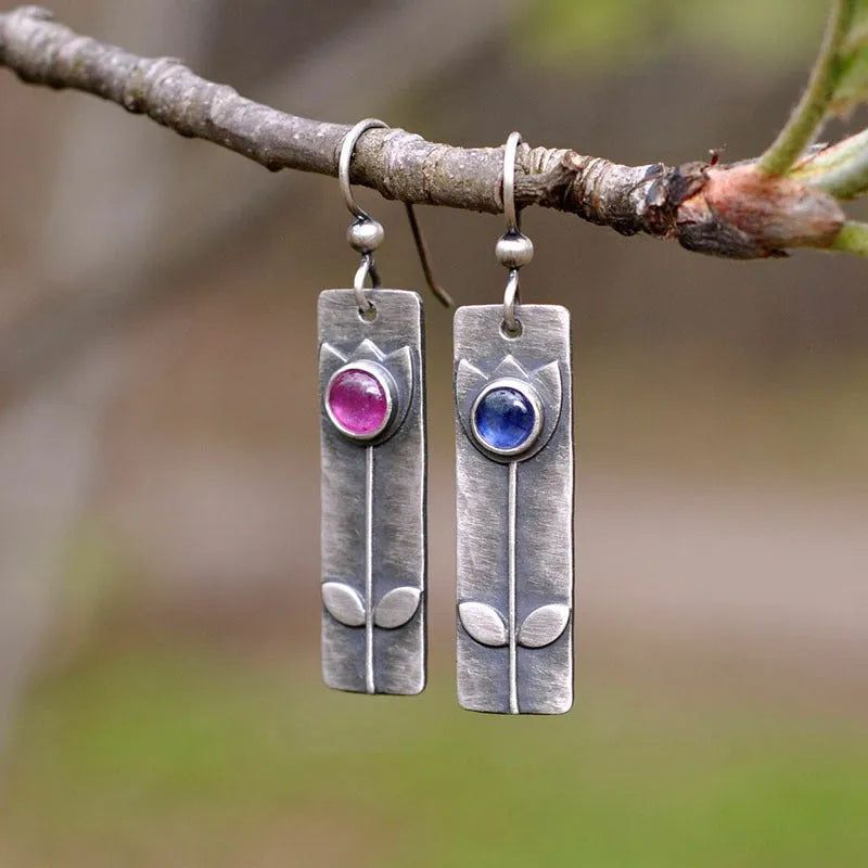 Antique finish geometric earrings with red sapphire ellipse details on electroplated metal