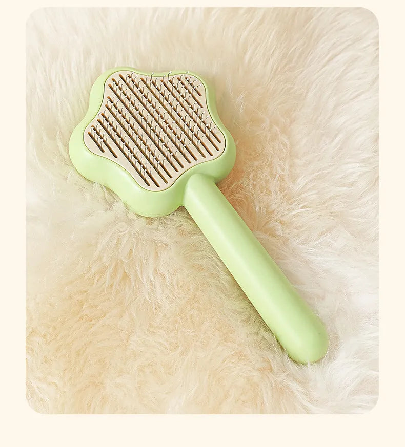 Self-cleaning pet grooming comb with stainless steel needles showing green colour option