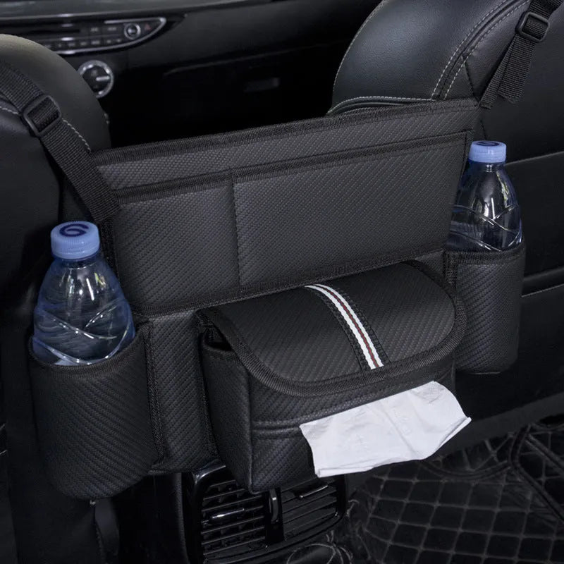 Black leather car seat hanging organiser bag holding a tissue box between vehicle front seats.