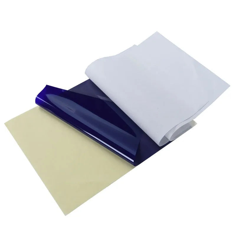 Stack of A4 tattoo transfer paper sheets showing quadruple copy layers for stencil making