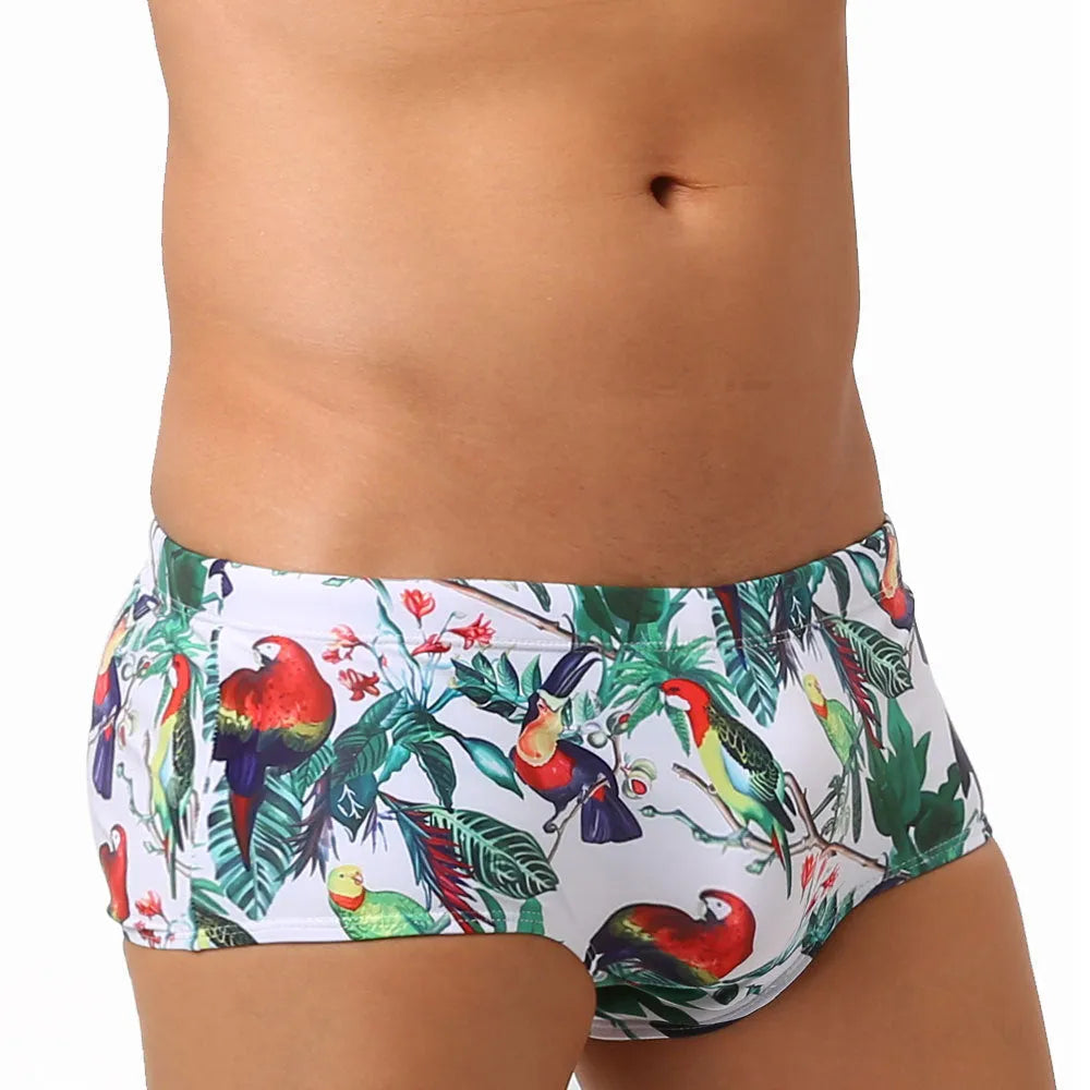 Men's navy swim trunks with colourful flower and bird print pattern, boxer style
