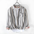 Man wearing a loose-fit red and grey striped linen long-sleeve casual shirt.