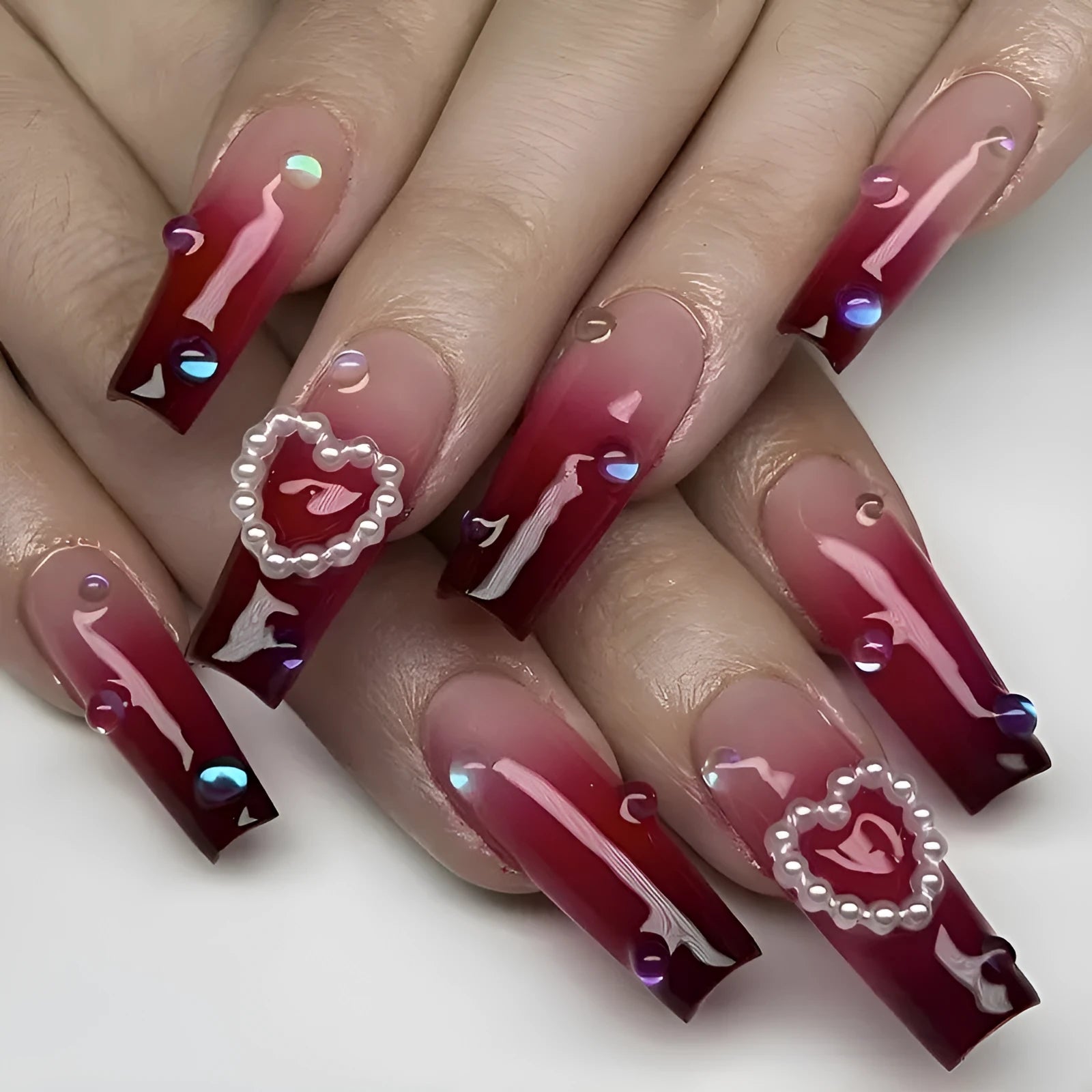 Wine red gradient fake nail tips with a pearl heart and plaid design in a long ballet shape.