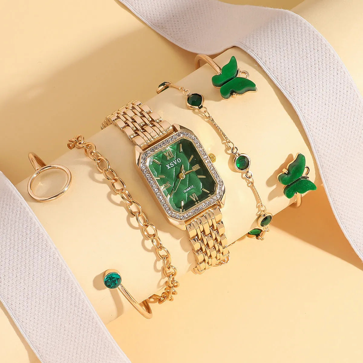 Gold green square watch with alloy case and four matching bracelets laid out showing jewellery buckle and spiral crown
