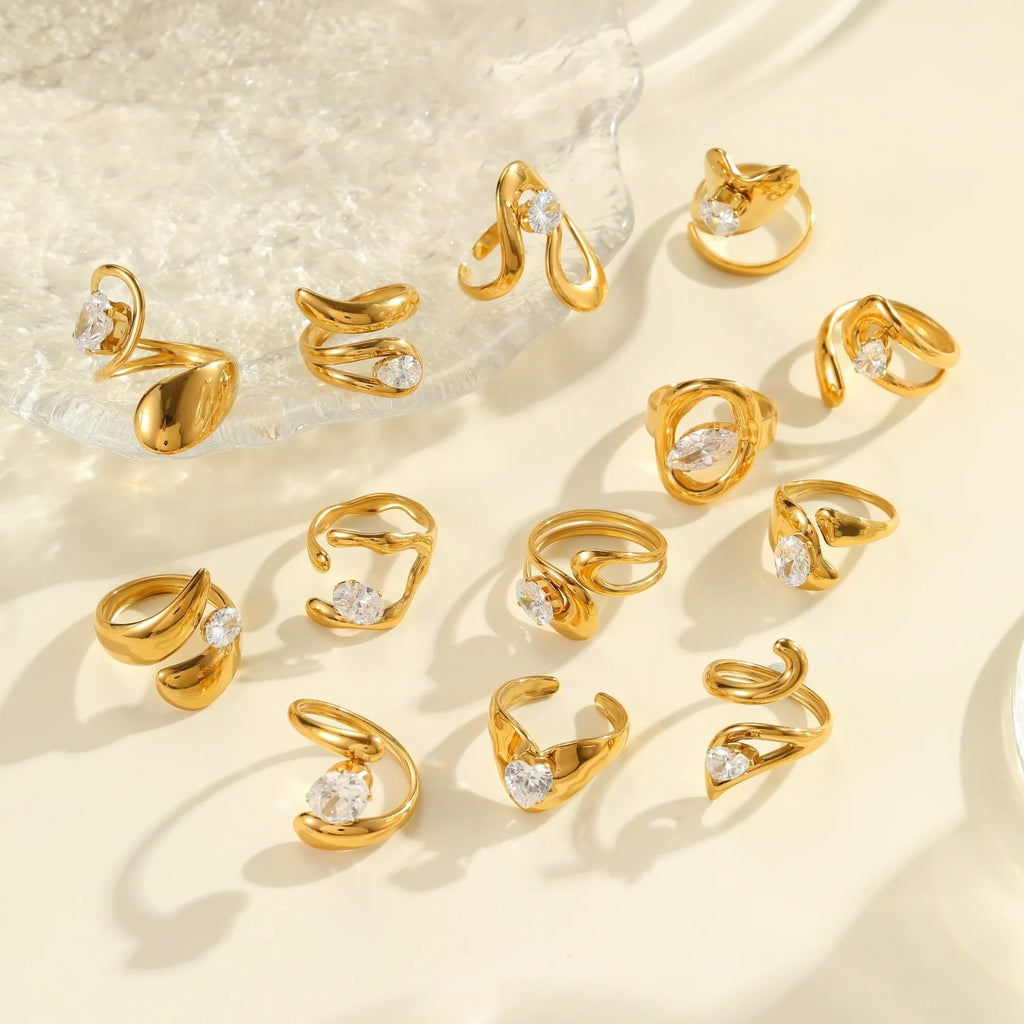 Geometric stainless steel open mouth ring with zircon detail and electroplated finish.