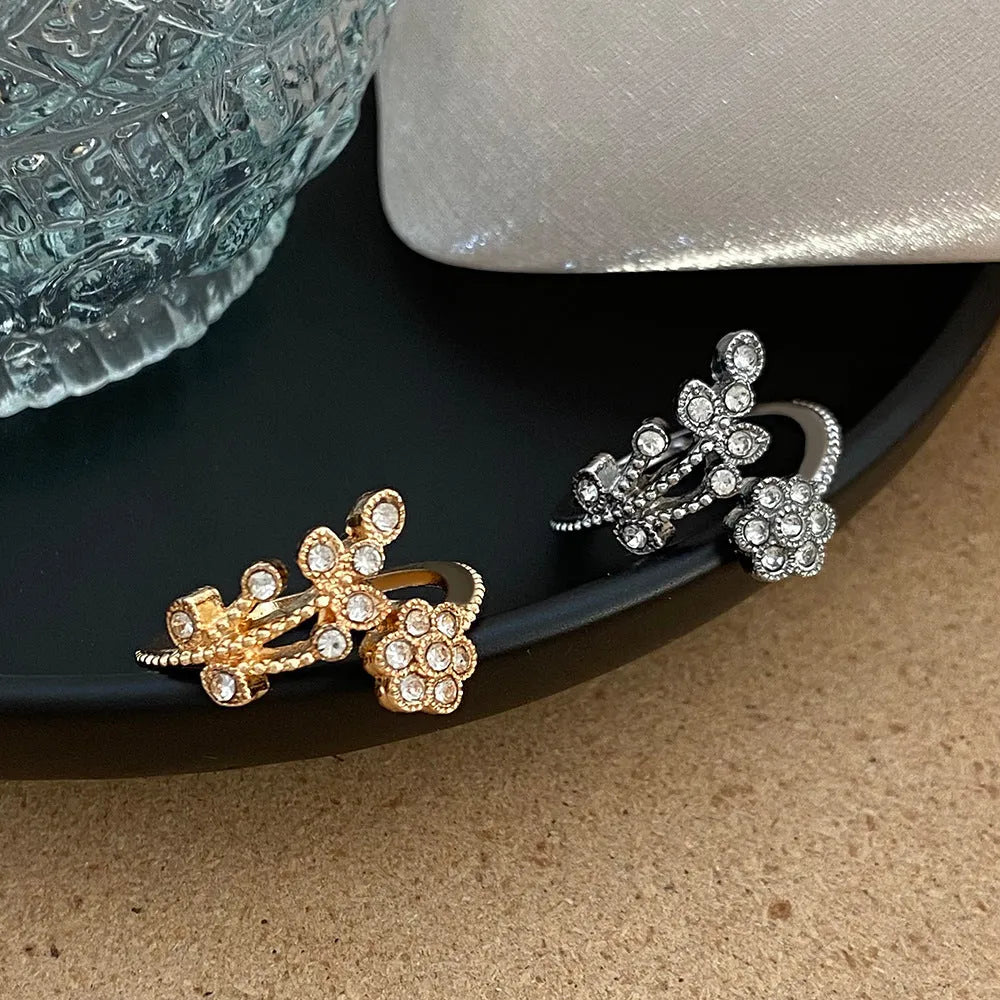 Copper open ring with diamond-treated floral and leaf decoration in gold colour