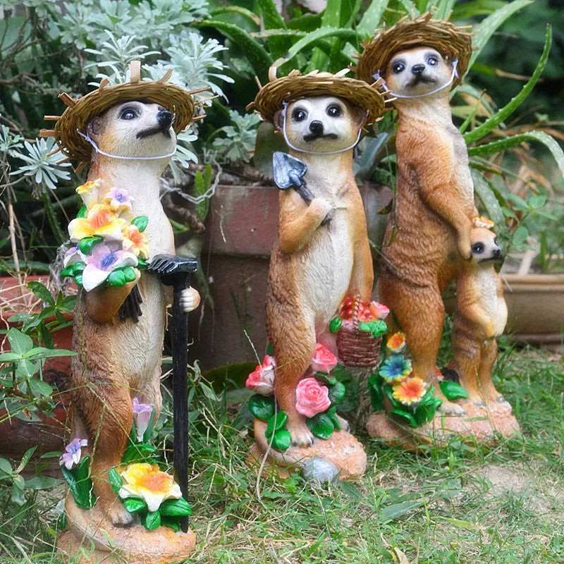 Yellow brown synthetic resin mongoose garden ornament wearing a straw hat and holding a rake or shovel for bonsai decoration