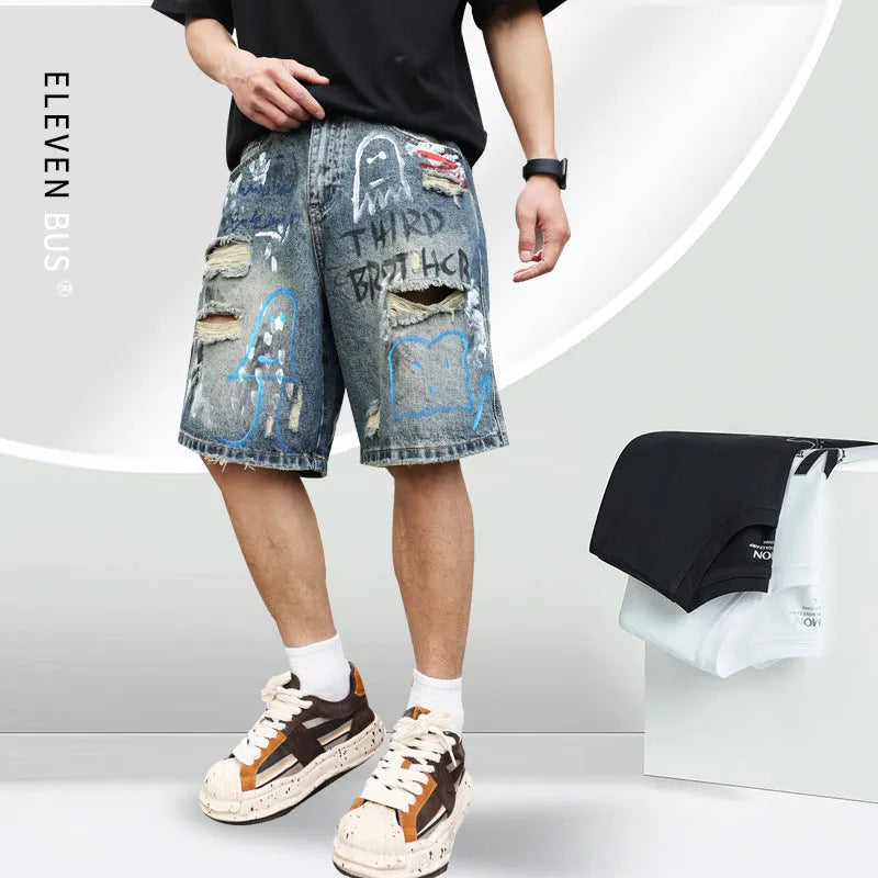 Blue distressed denim shorts with graffiti detail and ripped styling on mannequin