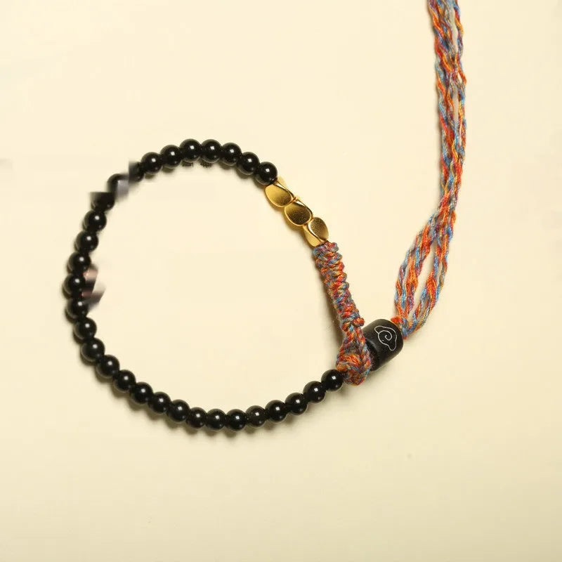 Hand-woven obsidian wrist bracelet showing 4mm width and textured strand construction
