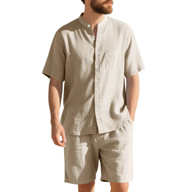 Men's light blue linen two-piece suit with short-sleeved henry collar shirt jacket and shorts on a hanger.