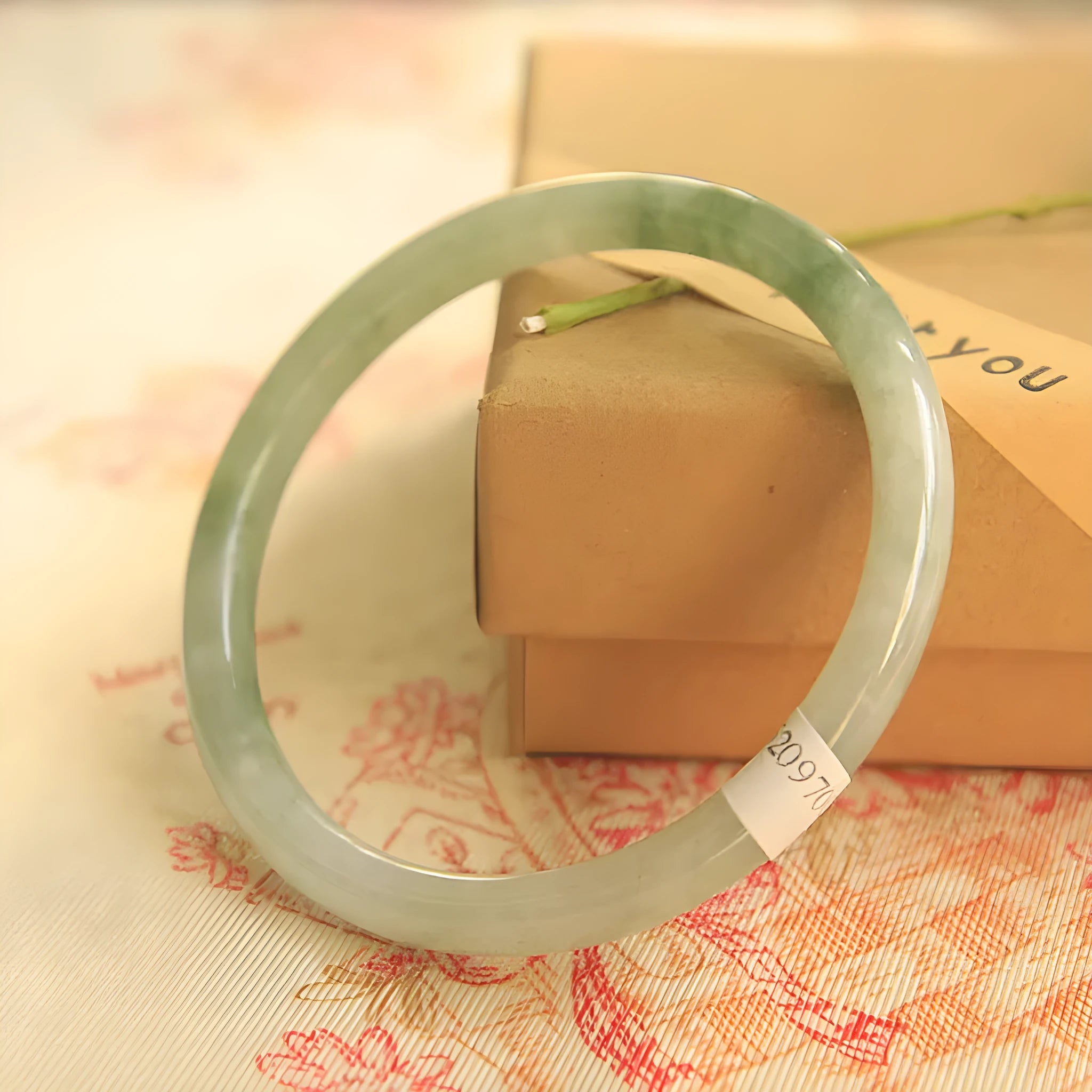 Green geometric jade waxy bracelet with 10mm diameter on a wrist.