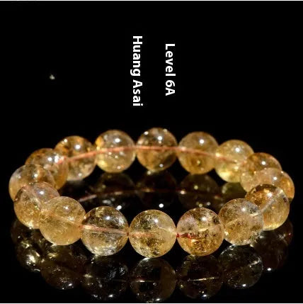 Natural yellow citrine gemstone bracelet showing geometric cut beads on a string.