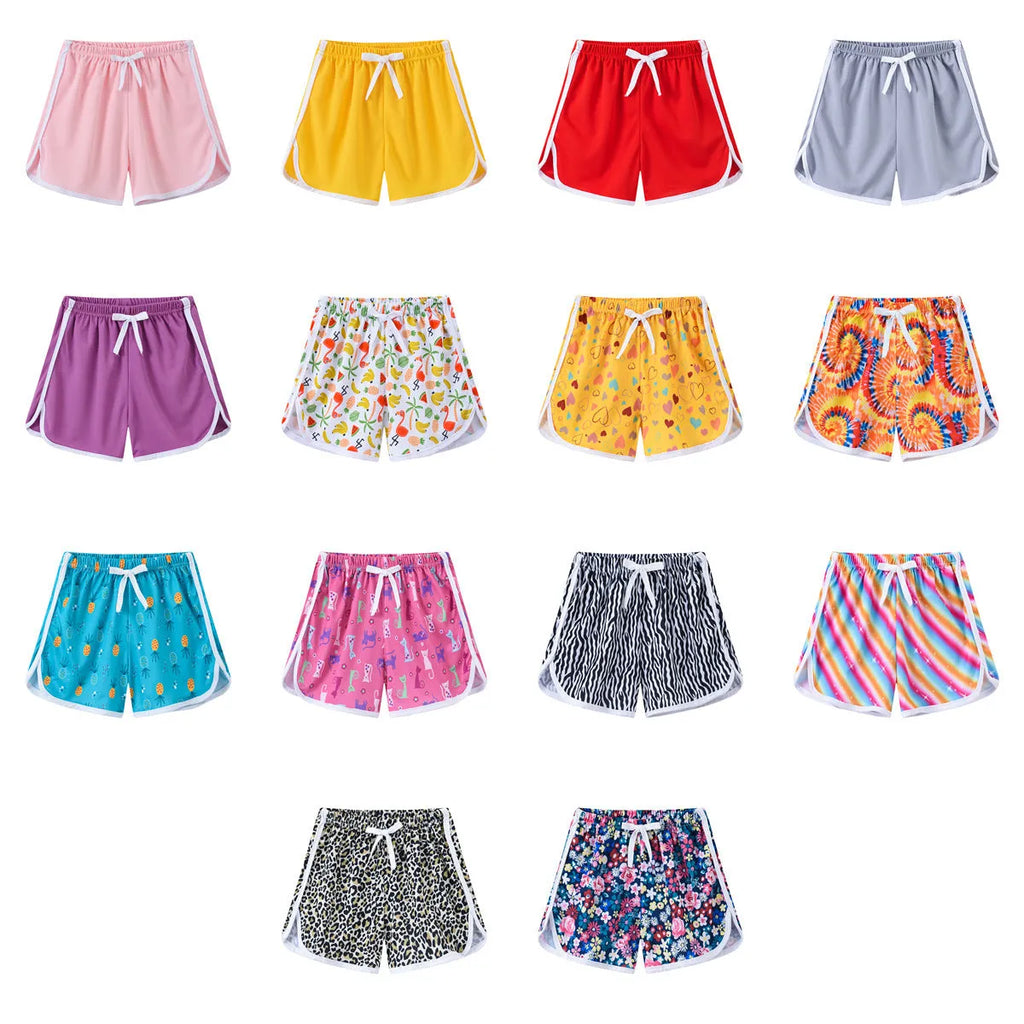 Children's polyester shorts in various colours and prints for beach holidays.