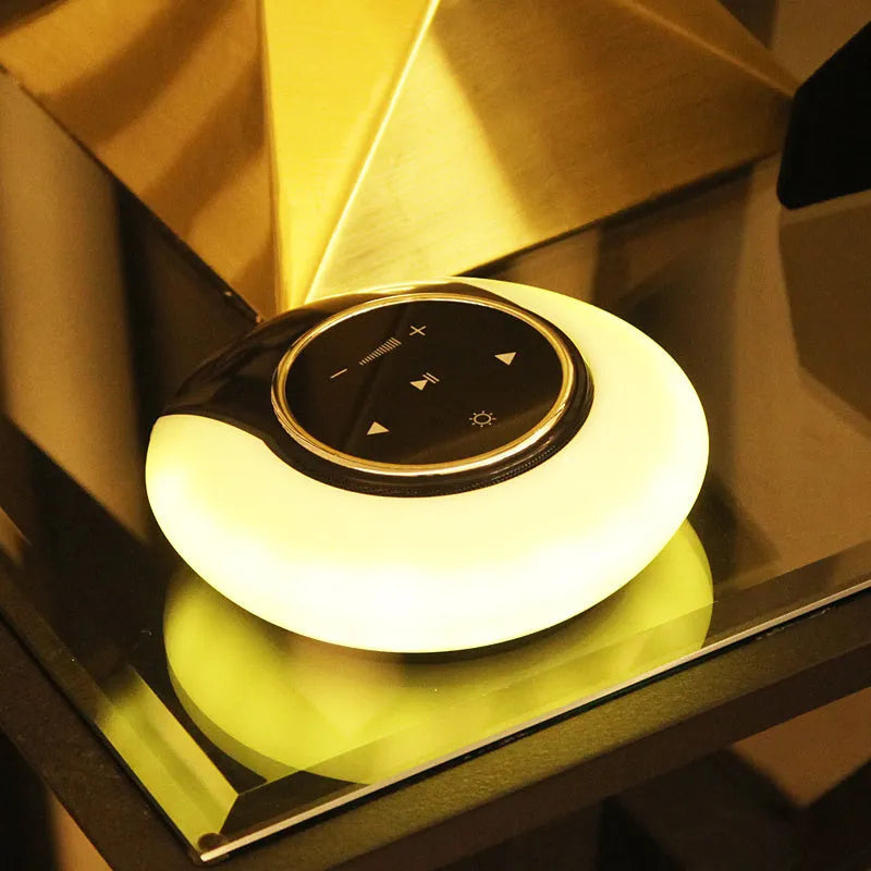 Blue and white Bluetooth desk lamp with speaker, shown folded and unfolded on a wooden desk