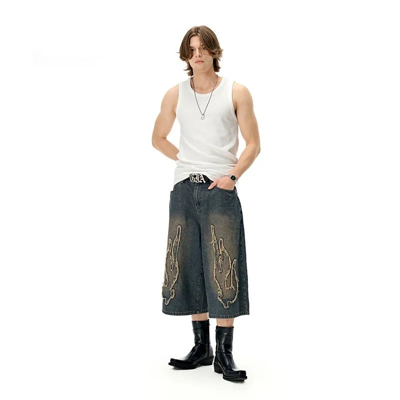 Men's black denim shorts with flame embroidery patch decoration and straight cut cropped design