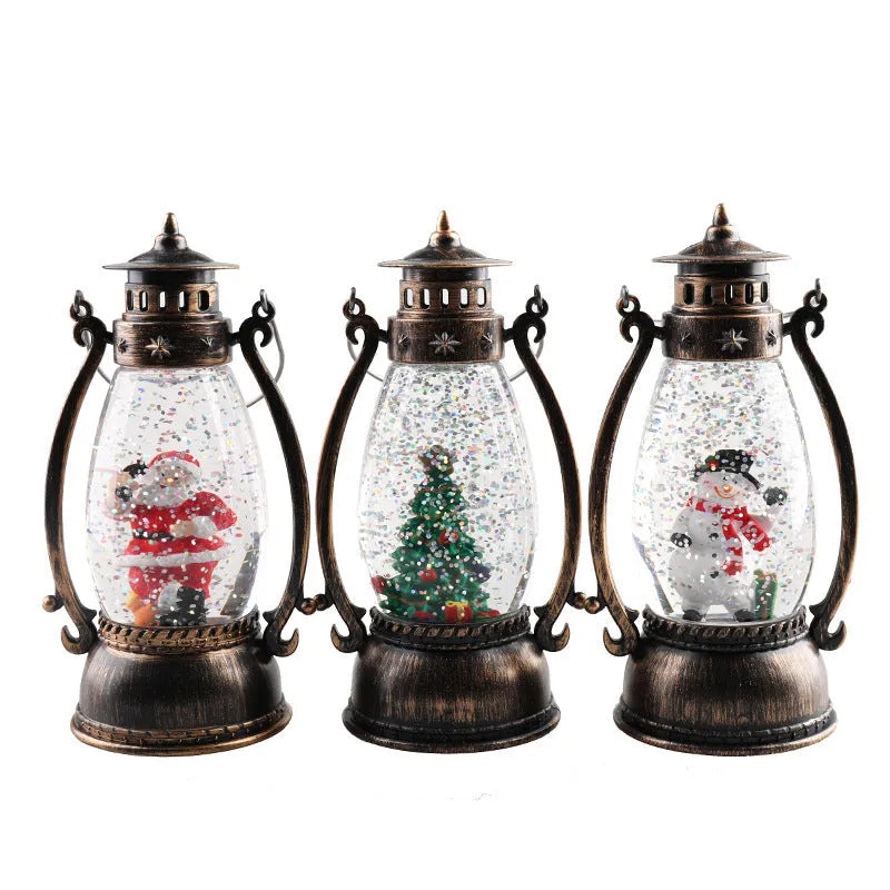 Plastic crystal ball LED oil lamp Christmas ornament with internal snowman figurine on a desktop.
